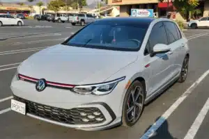 A car parked in a shopping center parking lot with a clean exterior