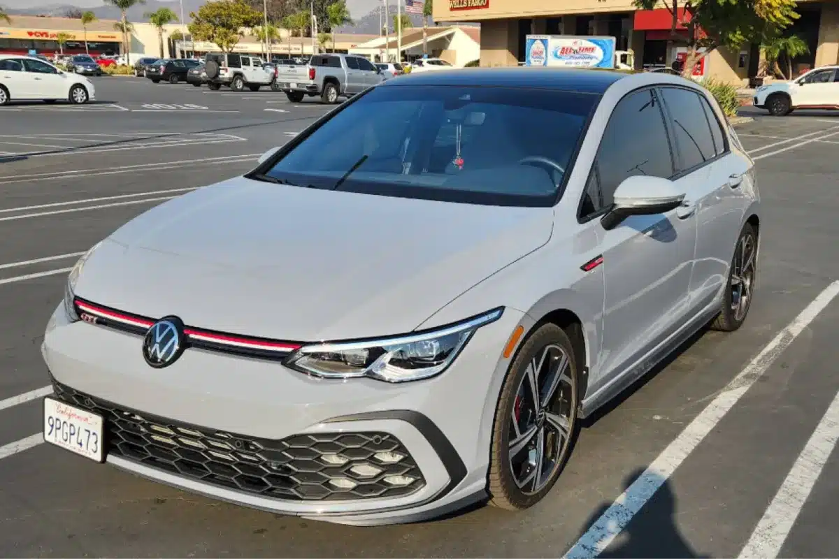 A car parked in a shopping center parking lot with a clean exterior