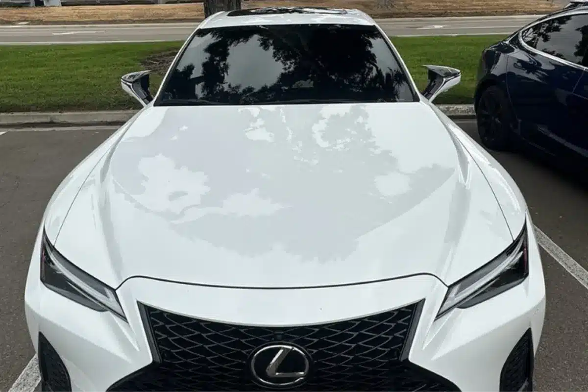 Front view of a white Lexus car with dark-tinted windows, parked outdoors.