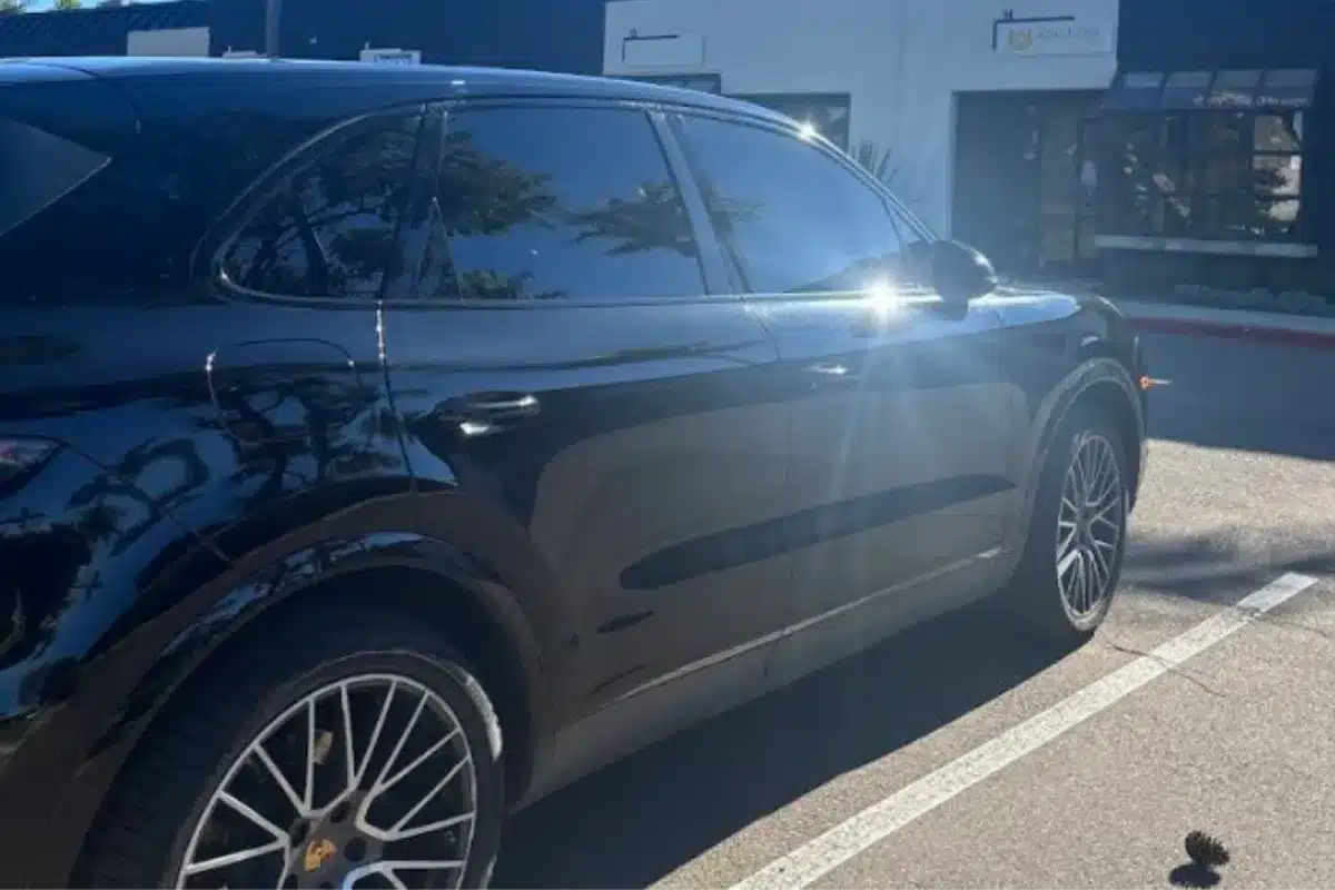 Side view of Porsche SUV with professional window tinting.