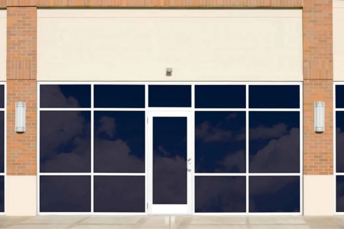 Commercial storefront with dark window tint installed for heat and glare reduction.