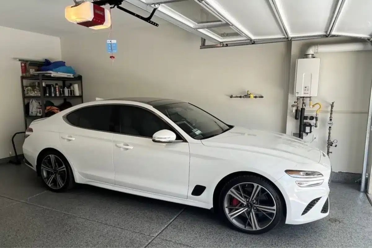 White Genesis sedan protected with ceramic coating in a garage.