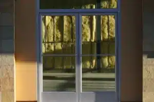 Commercial glass doors with reflective window tint.