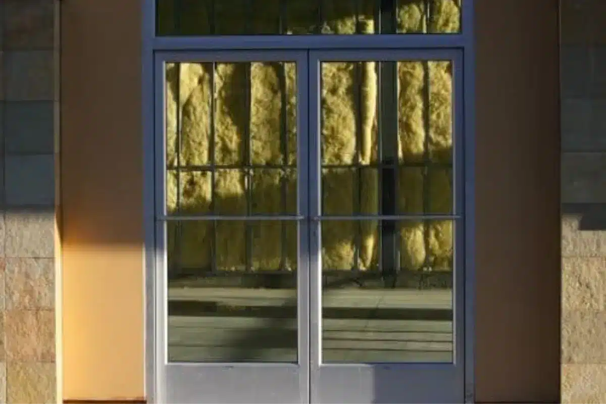 Commercial glass doors with reflective window tint.