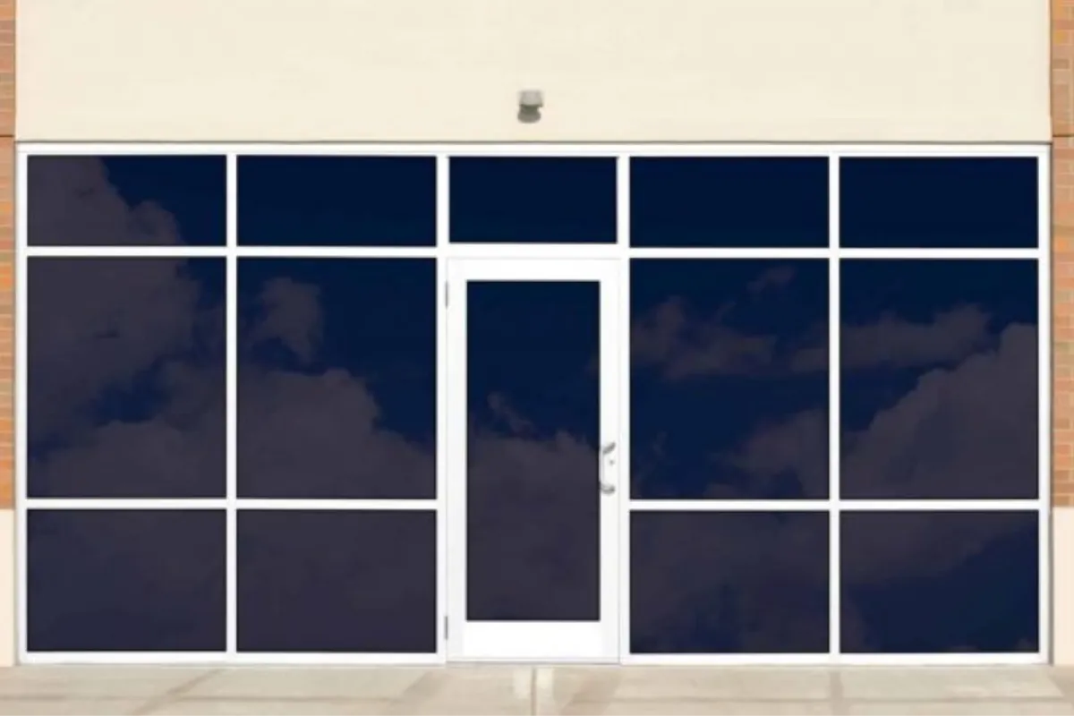 Commercial storefront windows with dark window tint installed.