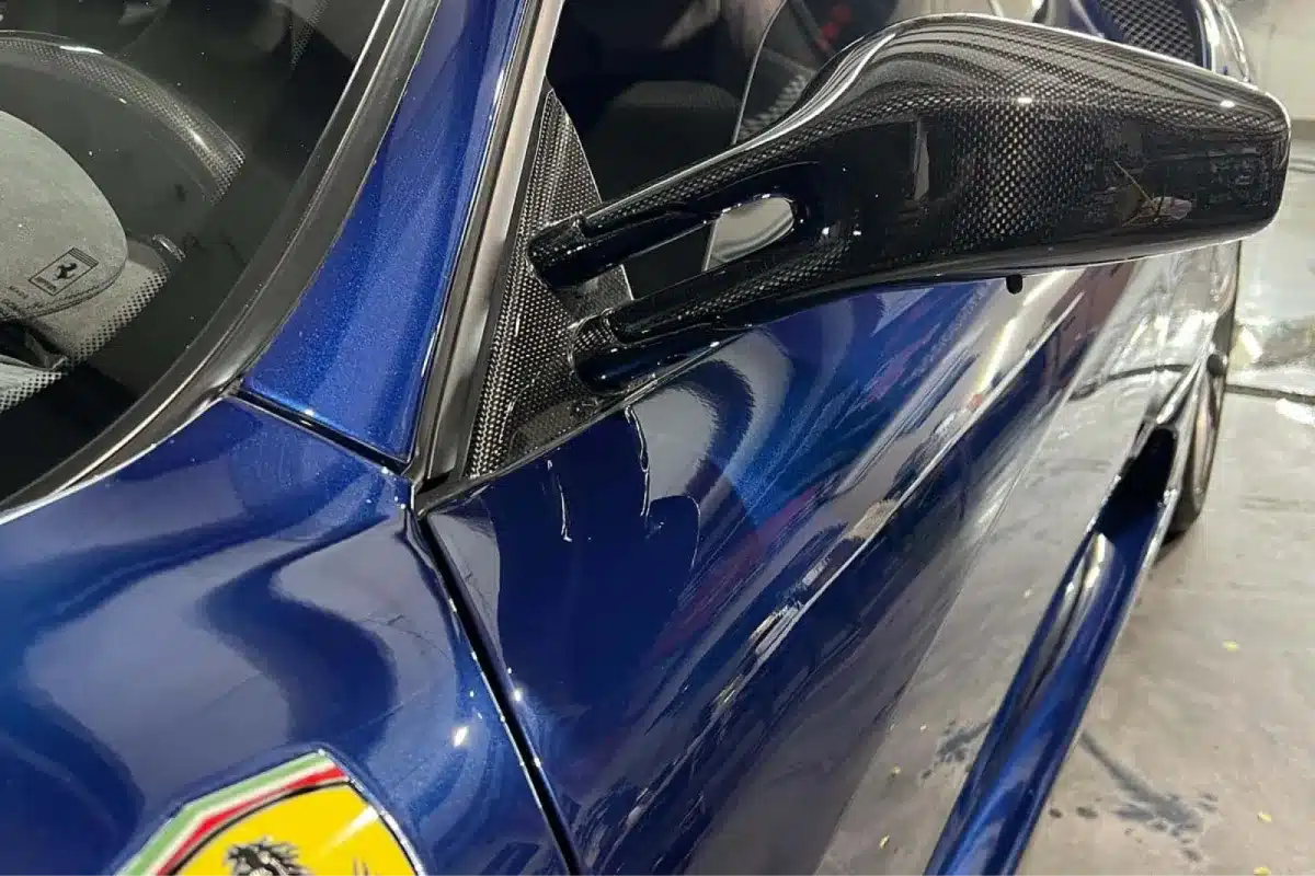 Blue Ferrari with paint protection film protecting the exterior finish.
