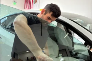 Professional window tinting installation on a car window.